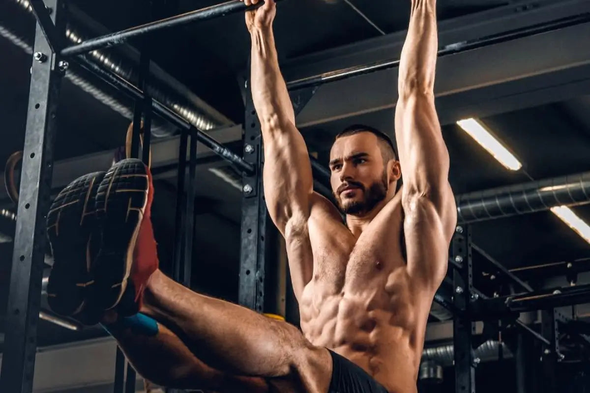 Athlete performing pull-ups in gym with sustained focus and concentration during intense training session